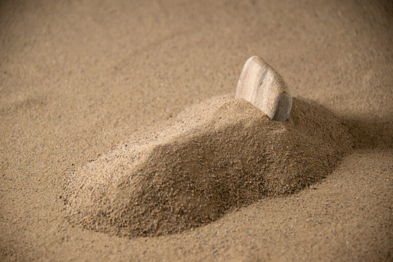 front-view-little-stone-grave-moon-sand
